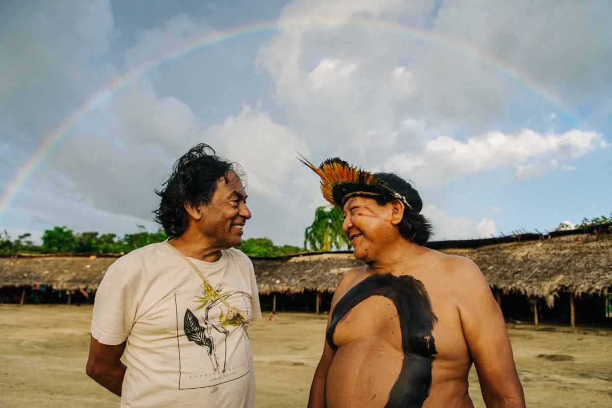 Ailton Krenak meets his longtime friend, Davi Kopenawa, in the center of Xihopi, Yanomami Indigenous Land